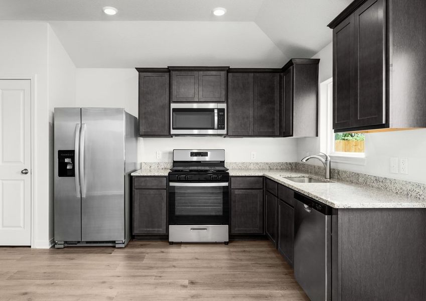 The kitchen has beautiful wood cabinetry.