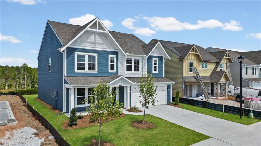 Front exterior of a new home in Twin Lakes, Hoschton, GA, highlighting curb appeal (Image 19). Front exterior of a new home in Twin Lakes, Hoschton, GA, highlighting curb appeal (Image 19).