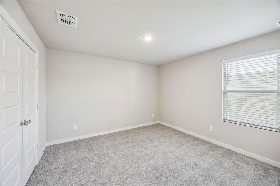 Bedroom in the Willow home plan by Trophy Signature Homes – REPRESENTATIVE PHOTO