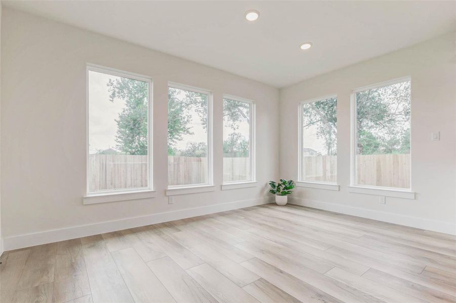 Sun-drenched space with large windows overlooking the back patio.Perfect for family meals or entertaining guests. Recessed lighting adds a polished touch.