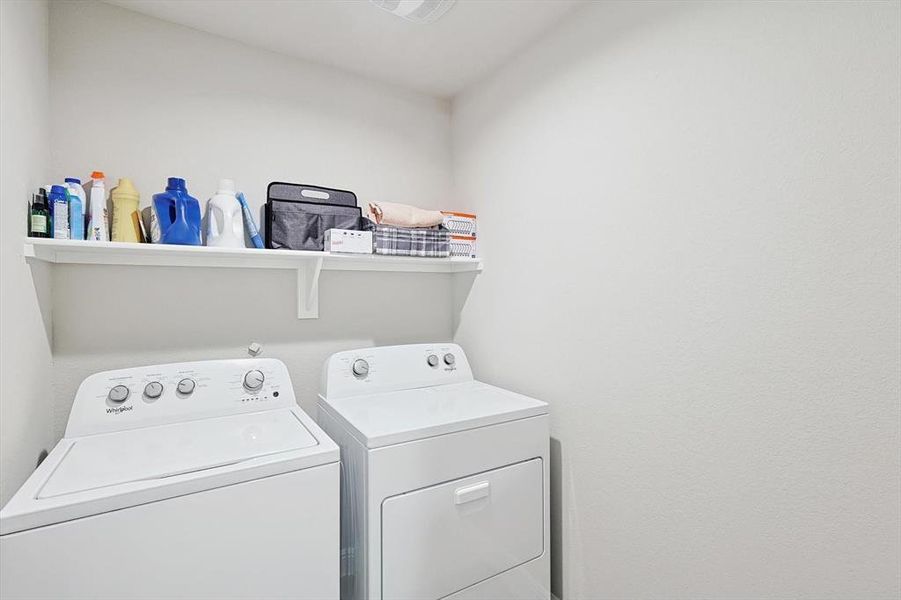 Clothes washing area featuring laundry area and washing machine and clothes dryer