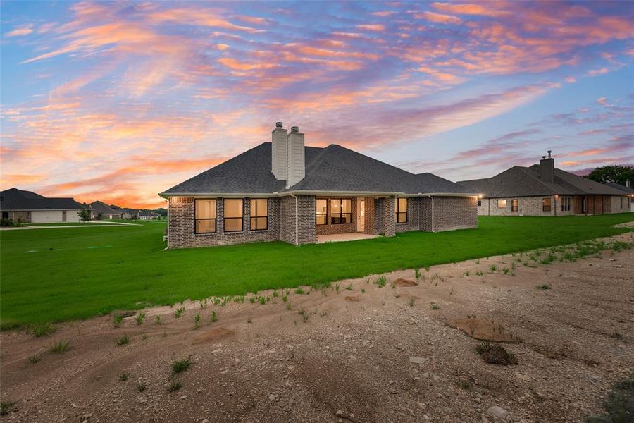 Front exterior of a new home in King Crossing Estates, Van Alstyne, TX, highlighting curb appeal (Image 14). Front exterior of a new home in King Crossing Estates, Van Alstyne, TX, highlighting curb appeal (Image 14).