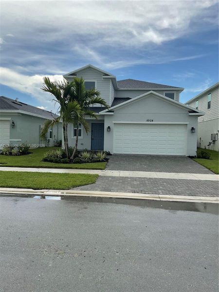 Front exterior of a new home in Brystol at Wylder, Port St. Lucie, FL, highlighting curb appeal (Image 2). Front exterior of a new home in Brystol at Wylder, Port St. Lucie, FL, highlighting curb appeal (Image 2).