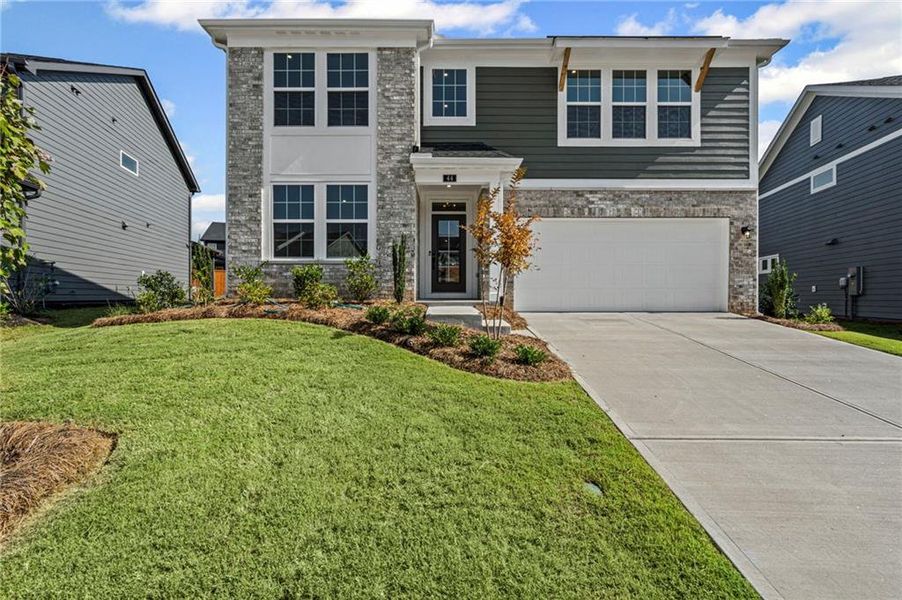 Front exterior of a new home in The Reserve At Liberty Park, Braselton, GA, highlighting curb appeal (Image 2). Front exterior of a new home in The Reserve At Liberty Park, Braselton, GA, highlighting curb appeal (Image 2).