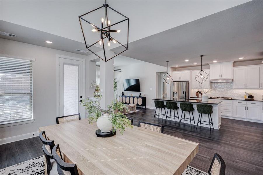 Dining area with recessed lighting, a chandelier, and dark wood finished floors