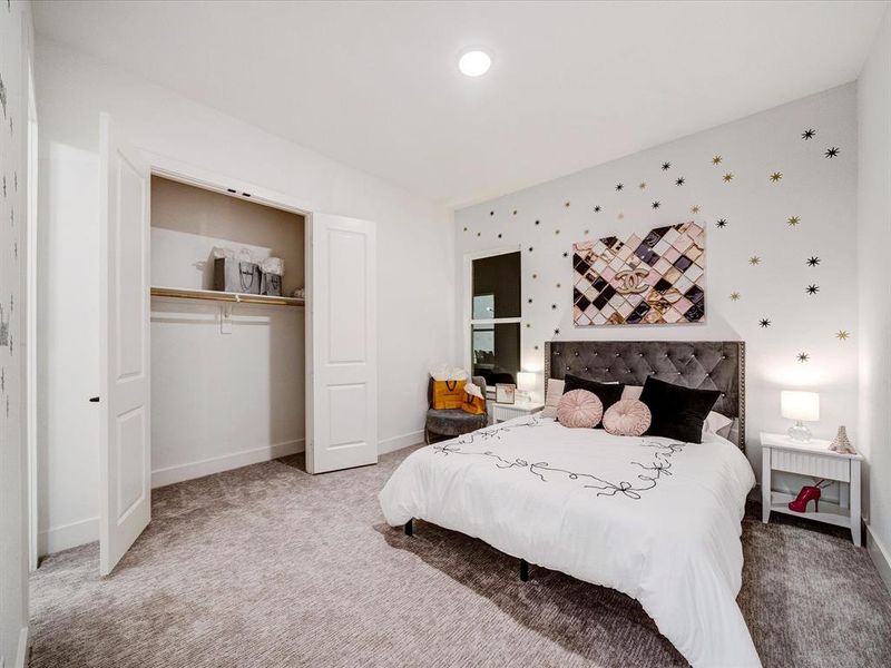 Bedroom featuring carpet floors and a closet Bedroom featuring carpet floors and a closet