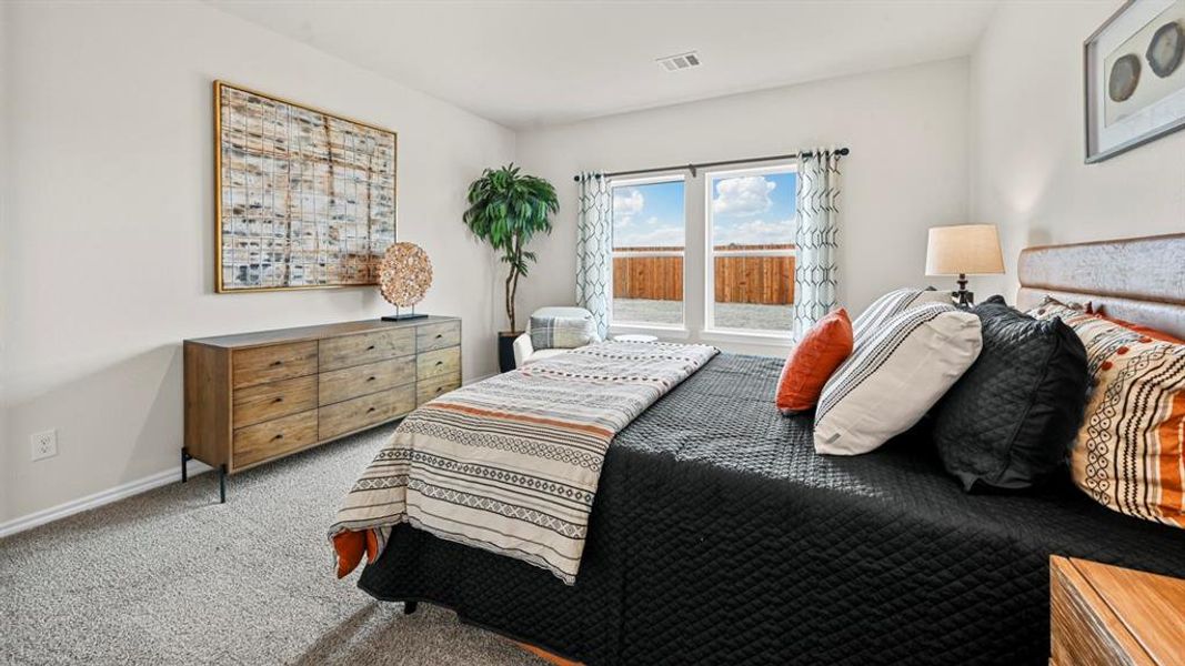Carpeted bedroom with baseboards