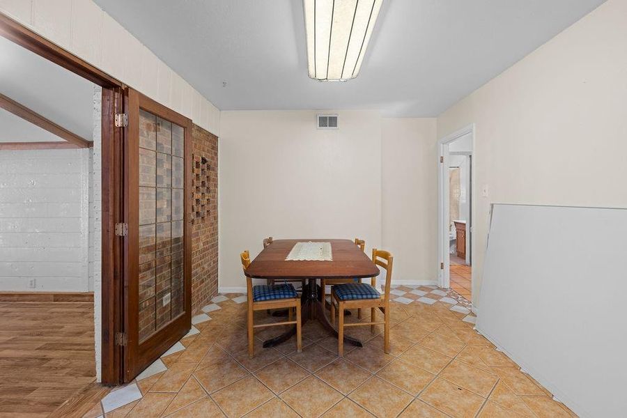 Dining area with light tile patterned floors