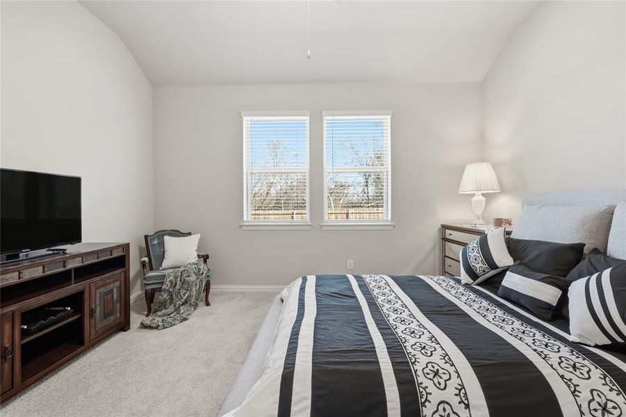 Bedroom featuring vaulted ceilings and light gray carpeting