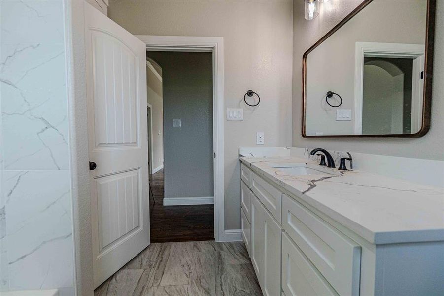 Bathroom featuring vanity and hardwood / wood-style flooring