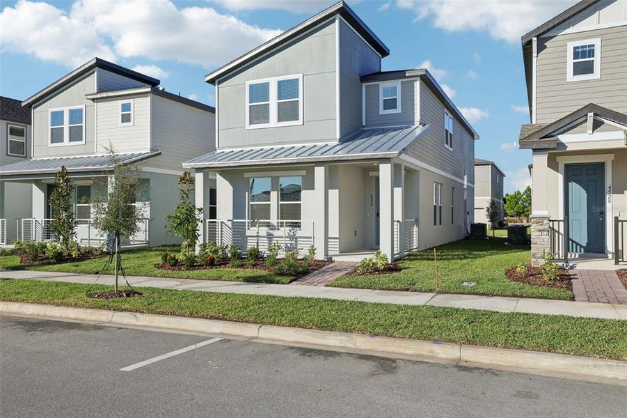Front exterior of a new home in The Meadow at Crossprairie Bungalows, St. Cloud, FL, highlighting curb appeal (Image 32).
