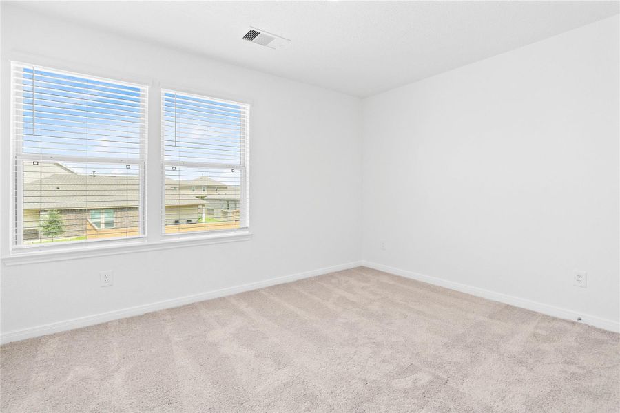 This secondary bedroom offers comfort and style with plush carpeting, neutral paint tones, recessed lighting, large windows with blinds, and a generously sized closet. This secondary bedroom offers comfort and style with plush carpeting, neutral paint tones, recessed lighting, large windows with blinds, and a generously sized closet.