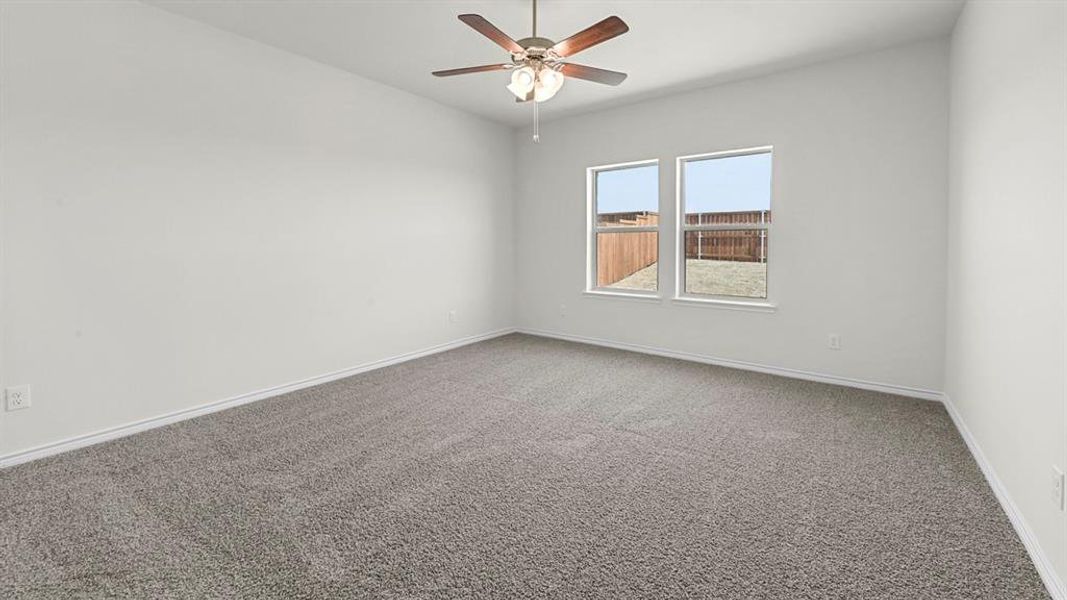 Spacious room featuring neutral carpeting and light-toned walls