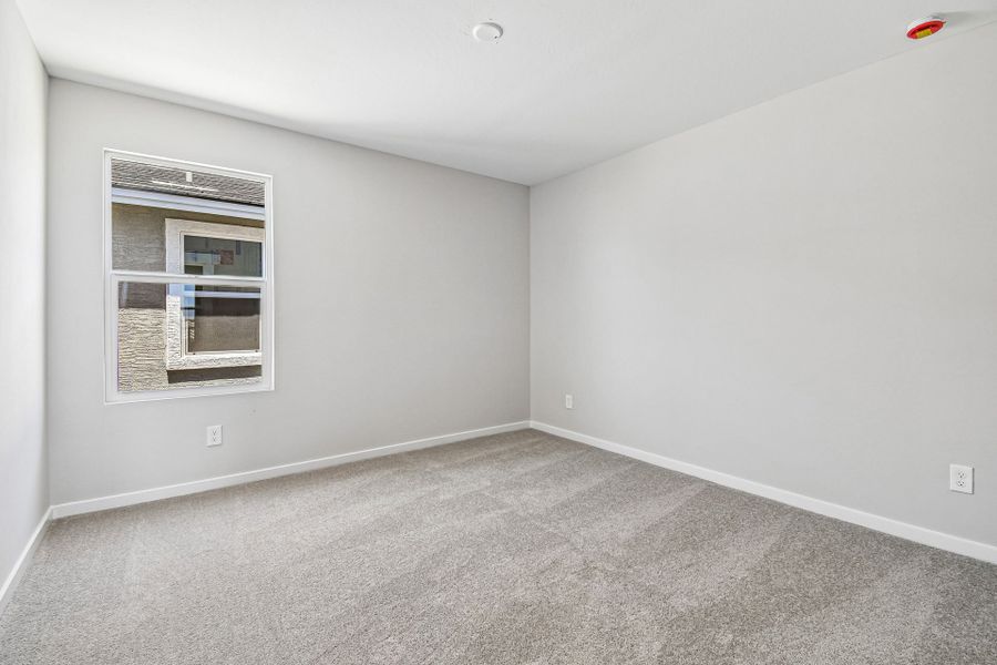 A room with a window and a carpet. A room with a window and a carpet.