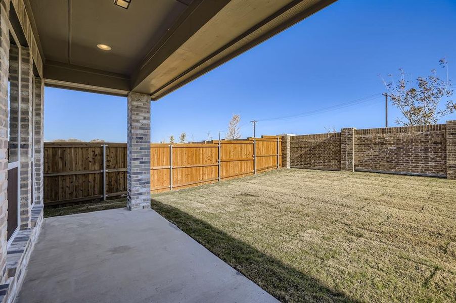Fenced backyard with a patio area