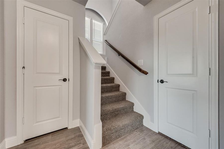 Staircase featuring wood finished floors and baseboards Staircase featuring wood finished floors and baseboards