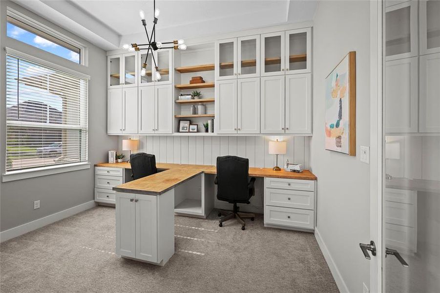 Elegant home office with two-level cabinetry and ample storage space.