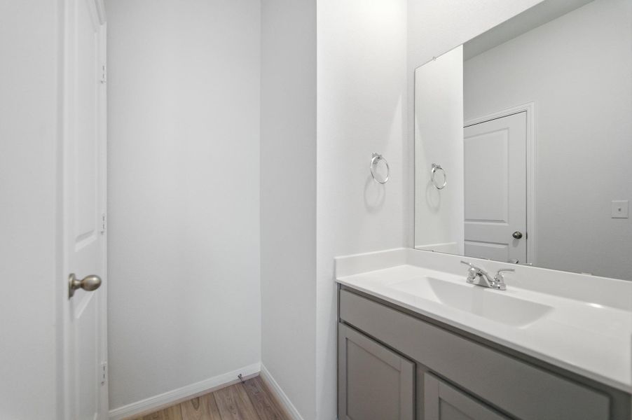 Bathroom with vanity and light wood finished floors