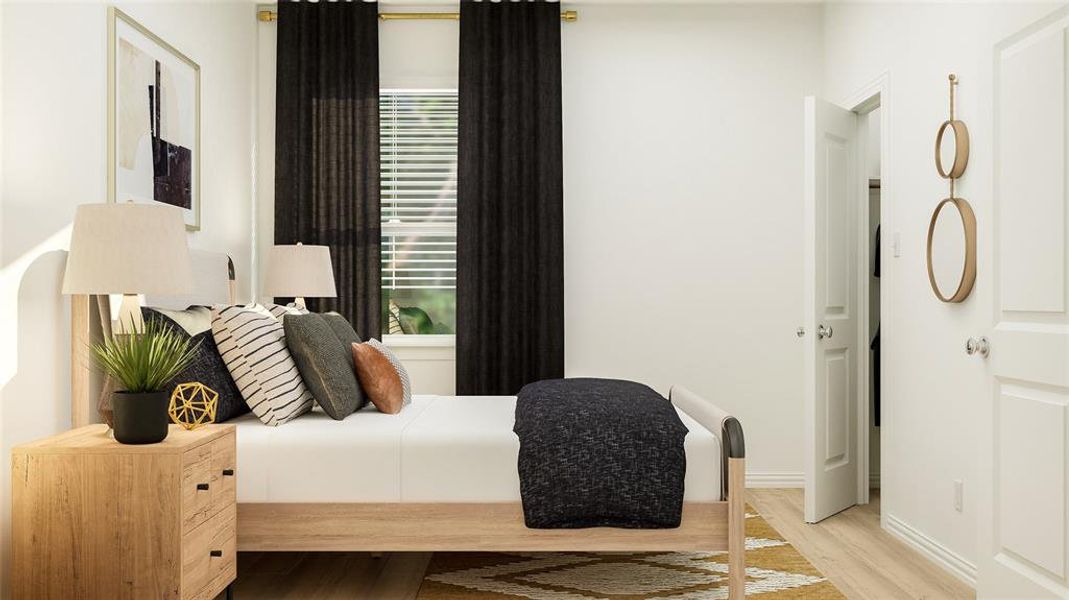 Bedroom with multiple windows and light hardwood / wood-style floors