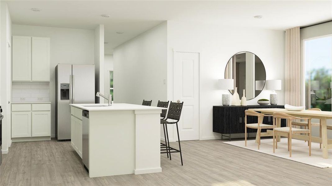 Kitchen featuring appliances with stainless steel finishes, a center island with sink, white cabinets, and light hardwood / wood-style flooring