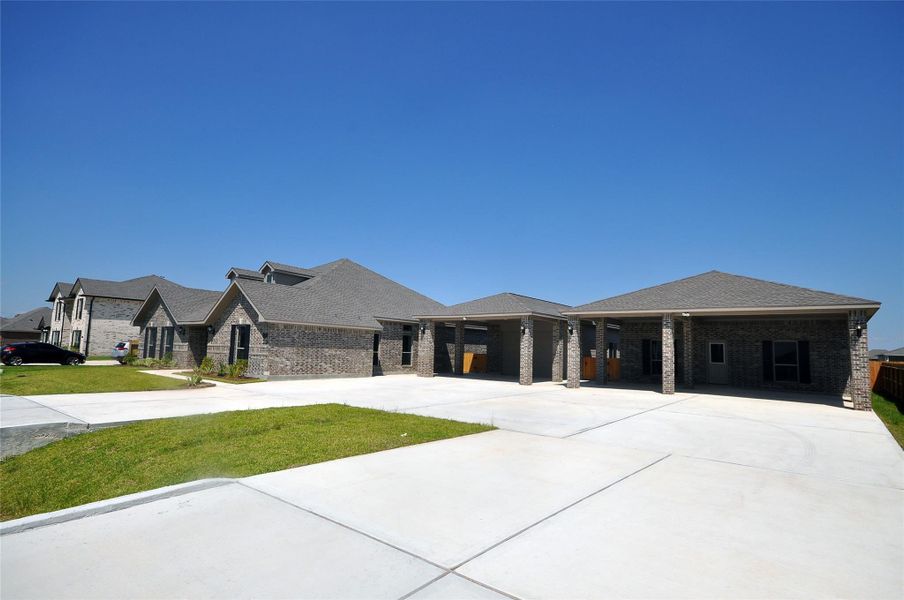 Front exterior of a new home in Pedregal, League City, TX, highlighting curb appeal (Image 25).
