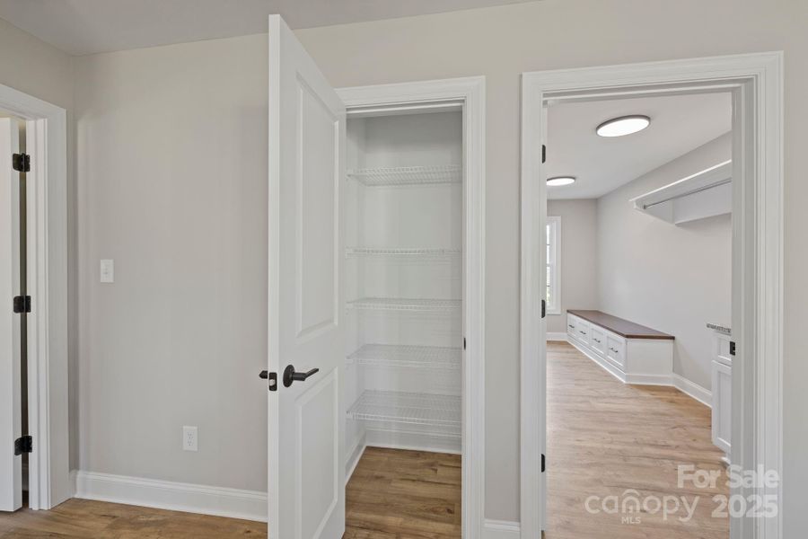 Convenient pantry with built-in shelving, offering easy and organized storage for everyday essentia Convenient pantry with built-in shelving, offering easy and organized storage for everyday essentia