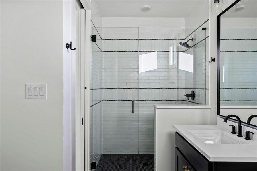 Bathroom with vanity and a shower stall Bathroom with vanity and a shower stall