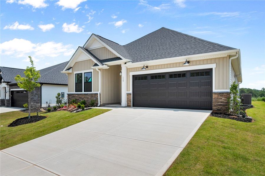 A striking modern residence boasts a dark garage d A striking modern residence boasts a dark garage d