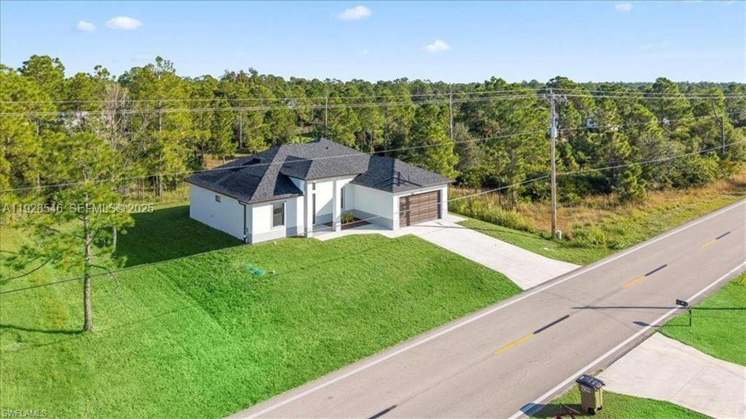 Front exterior of a new home in , Lehigh Acres, FL, highlighting curb appeal (Image 19).