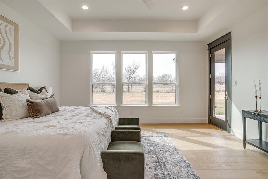 Primary bedroom with a gorgeous view & entrance to patio