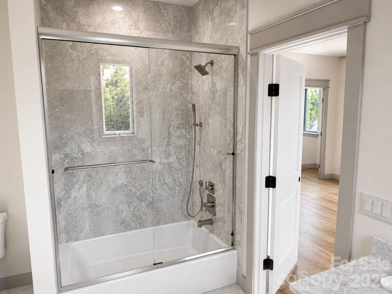 Upstairs features a split bedroom floorplan with two bedrooms each with an ensuite bath with floor to ceiling tile.