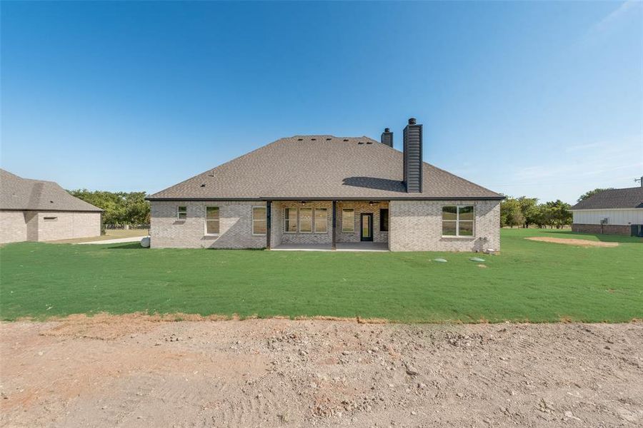 Rear view of property featuring a yard