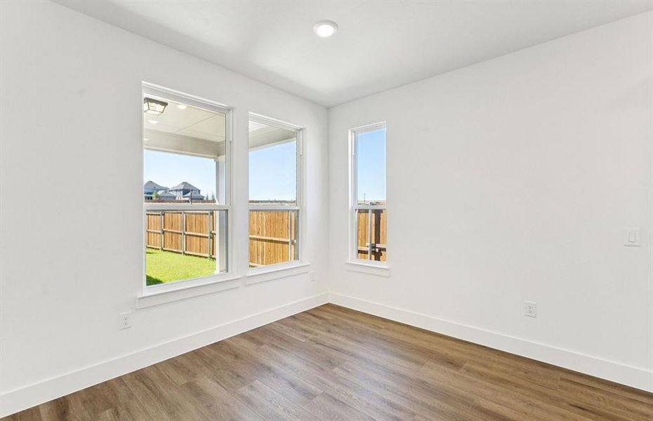 Dining nook off kitchen with large windows
