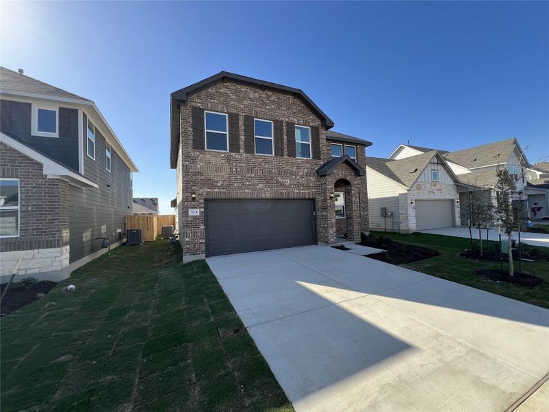 Front exterior of a new home in Rolling Glen, Hutto, TX, highlighting curb appeal (Image 19).