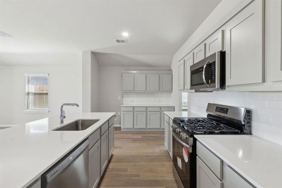Kitchen in the Harrison home plan by Trophy Signature Homes – REPRESENTATIVE PHOTO