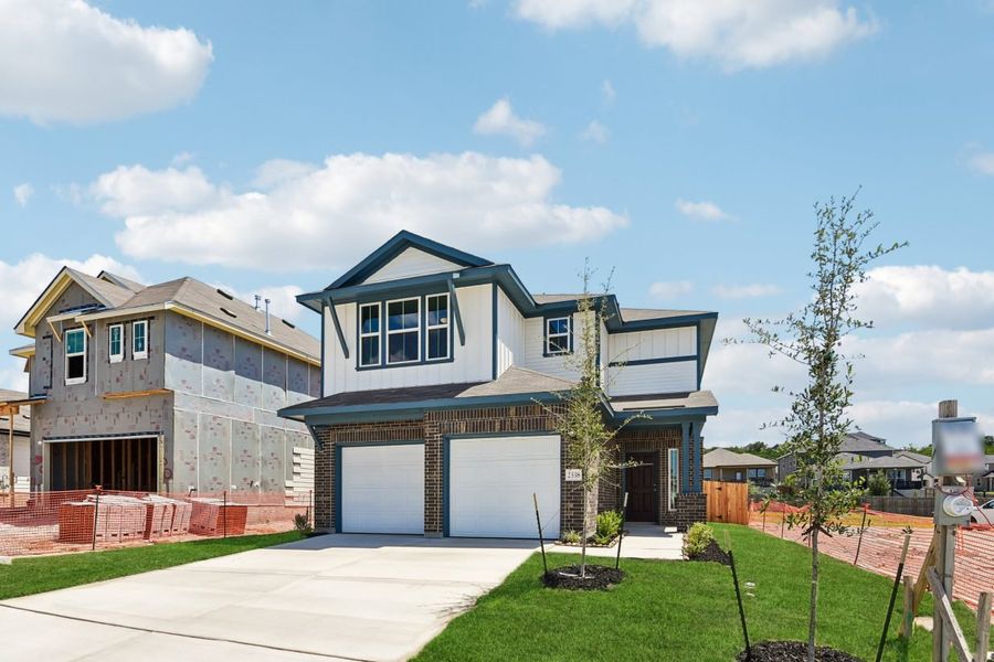 Front exterior of a new home in Hunters Ranch, San Antonio, TX, highlighting curb appeal (Image 17).