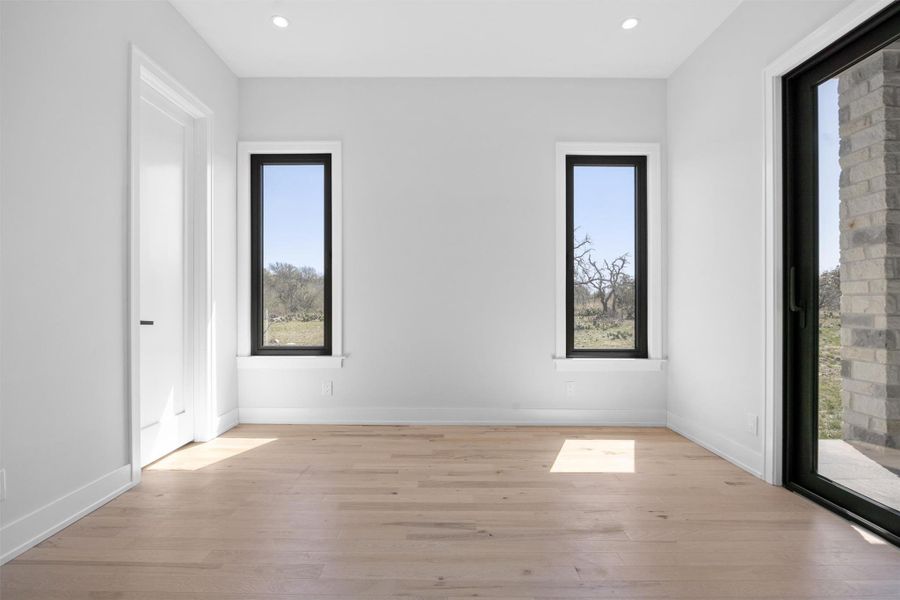 Room featuring glass door, recessed lighting, light wood-style floors