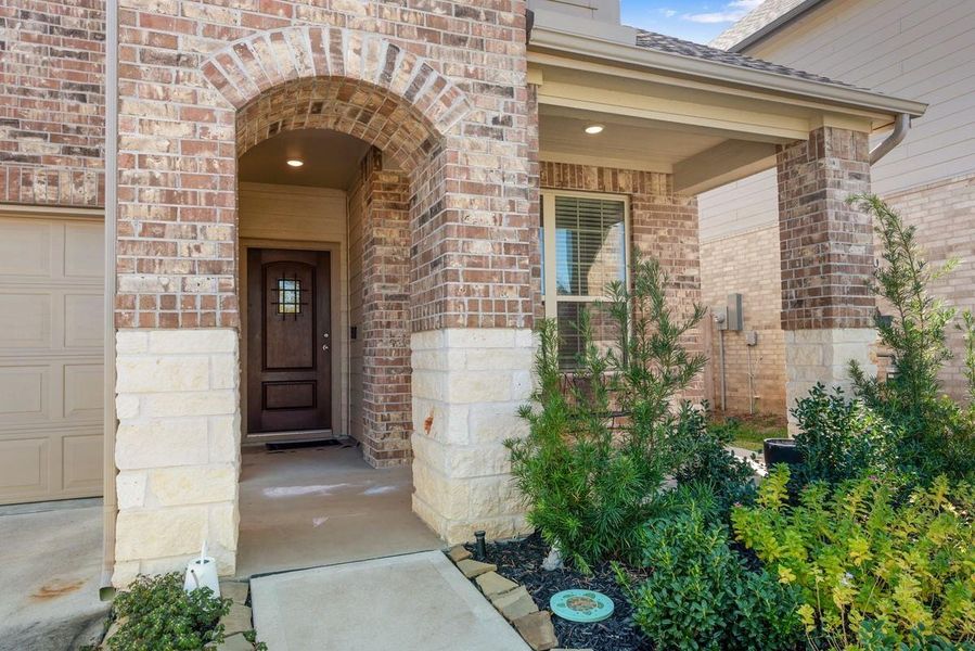Beautiful stone and brick work enhances the front porch and entry. Beautiful stone and brick work enhances the front porch and entry.