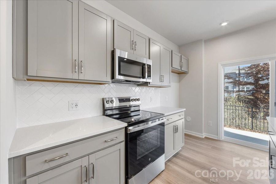 Kitchen with oven range, microwave and dishwasher Kitchen with oven range, microwave and dishwasher