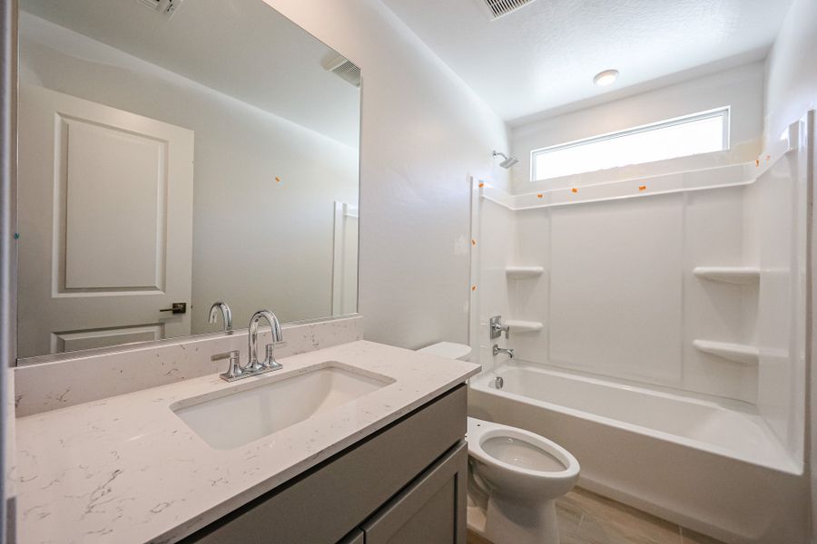 A bathroom with a sink and a toilet. A bathroom with a sink and a toilet.