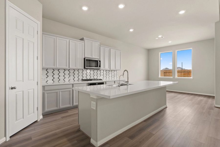 Kitchen and dining area. Note: Sample product photo. Actual exterior and interior selections may vary by homesite. Photo may be virtually staged