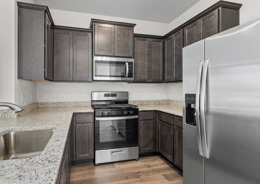 The kitchen has designer wood cabinetry.