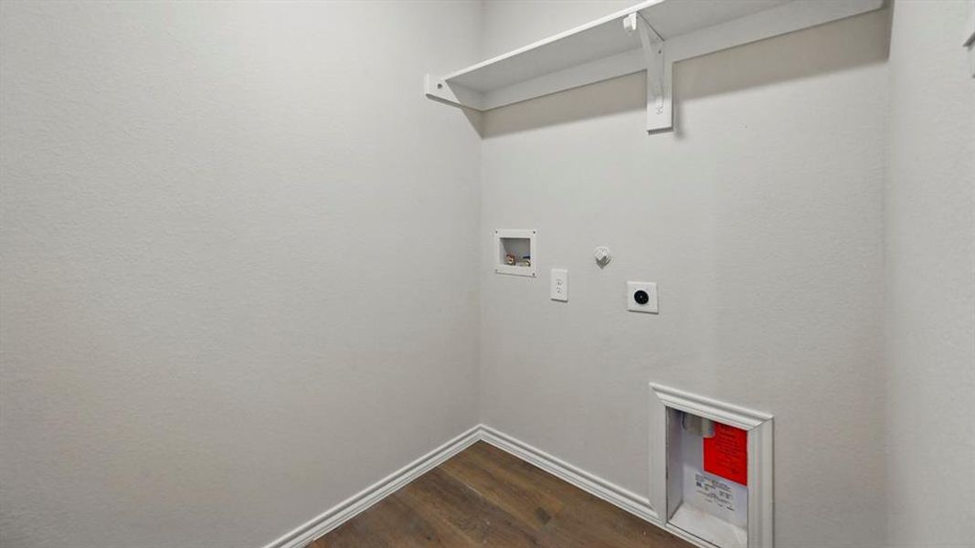 Laundry room with hookup for a gas dryer, washer hookup, dark wood-type flooring, and electric dryer hookup