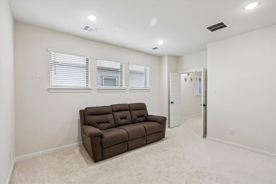 Carpeted room with recessed lighting and three windows featuring white blinds Carpeted room with recessed lighting and three windows featuring white blinds