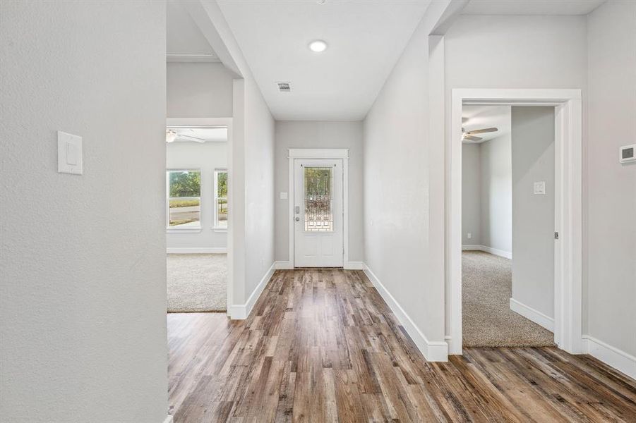 Entryway with ceiling fan and wood finished floors Entryway with ceiling fan and wood finished floors