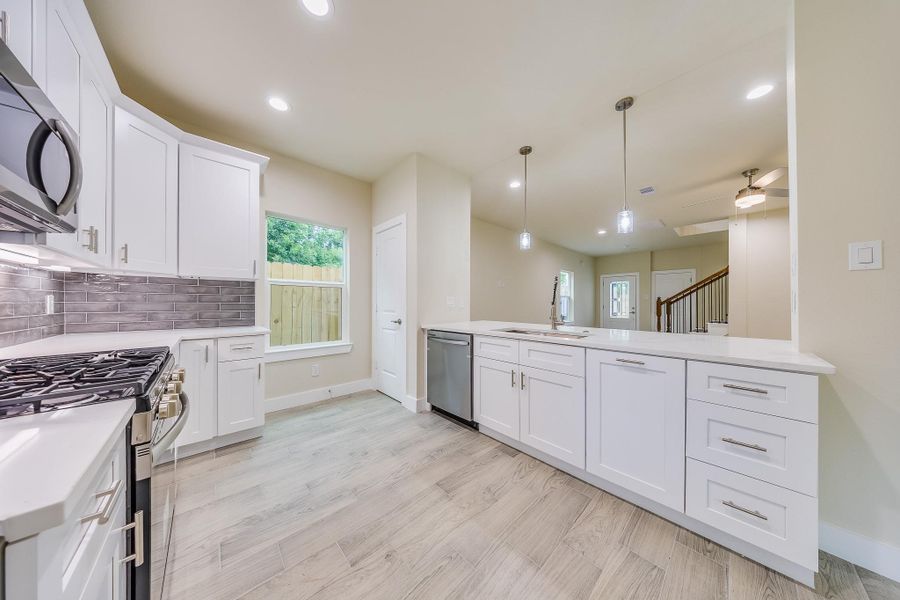 Welcome to 10514 Exeter St! Check out this Kitchen with quartz countertops and white cabinetry, combining elegance that show a modern style. See it for yourself today! Welcome to 10514 Exeter St! Check out this Kitchen with quartz countertops and white cabinetry, combining elegance that show a modern style. See it for yourself today!