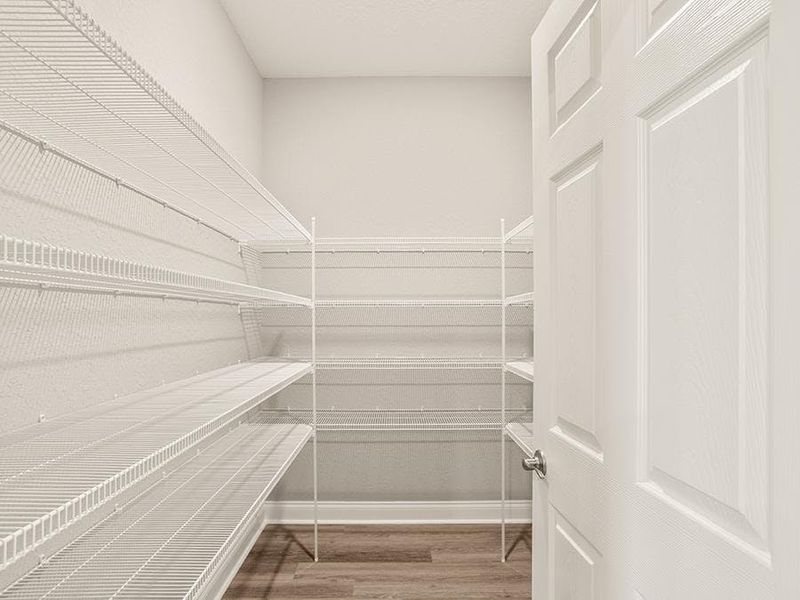You will find convenient features throughout, such as this walk-in pantry - Monroe 55+ by Highland Homes