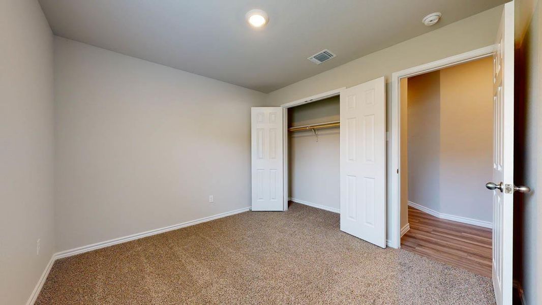 Neutral wall paint, brown carpet flooring, and a single ceiling light fixture