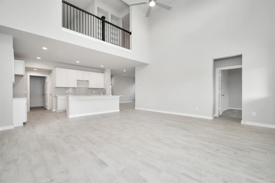 Another view of the living room area, heart of the home. Sample photo of completed home with similar floor plan. As-built interior colors and selections may vary.