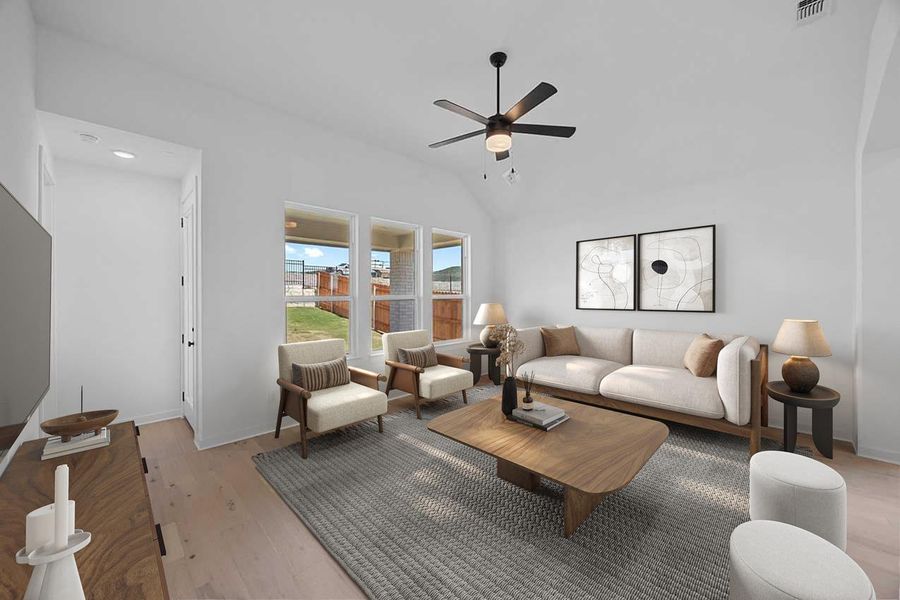 Living area featuring ceiling fan, light wood finished floors, vaulted ceiling, and recessed lighting
